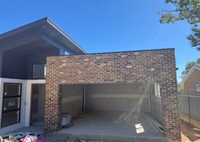 Completed brick facade and garage frontage at a residential property