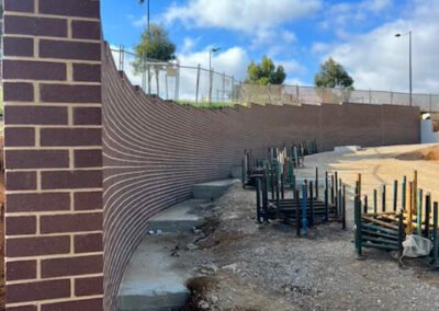 Side boundary wall with detailed brickwork beside a residential property