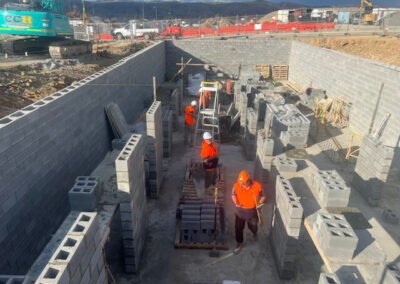 Workers completing blockwork on a large-scale below-ground project